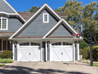 Traditional wooden car garage with driveway